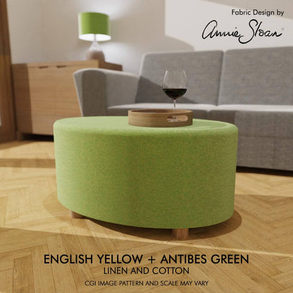 Oval coffee table footstool dressed in Annie Sloan's linen union fabric English Yellow and Antibes Green, embodying a fusion of relaxed luxury and vintage-inspired style.