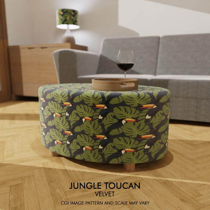 Oval coffee table footstool draped in soft velvet featuring Jungle Toucan design, adding a vibrant burst of tropical colour and exotic flair to your space.