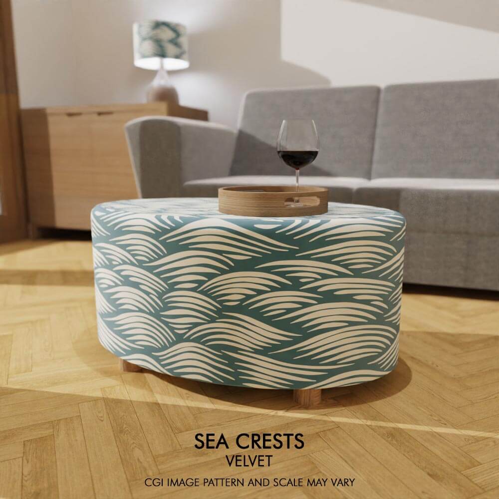 Oval coffee table footstool adorned in soft velvet embellished with Sea Crests design, bringing the calming essence of the sea into your living space.