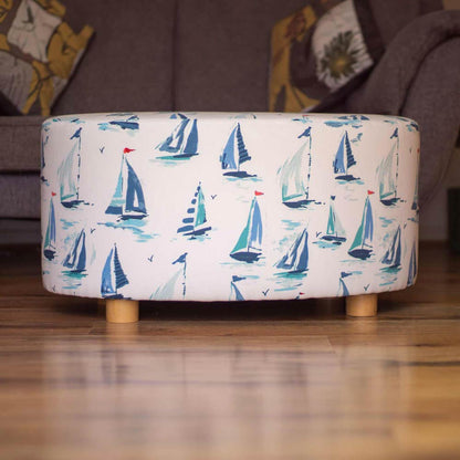 Oval coffee table footstool upholstered in St Ives fabric, showcasing coastal charm and relaxed sophistication.